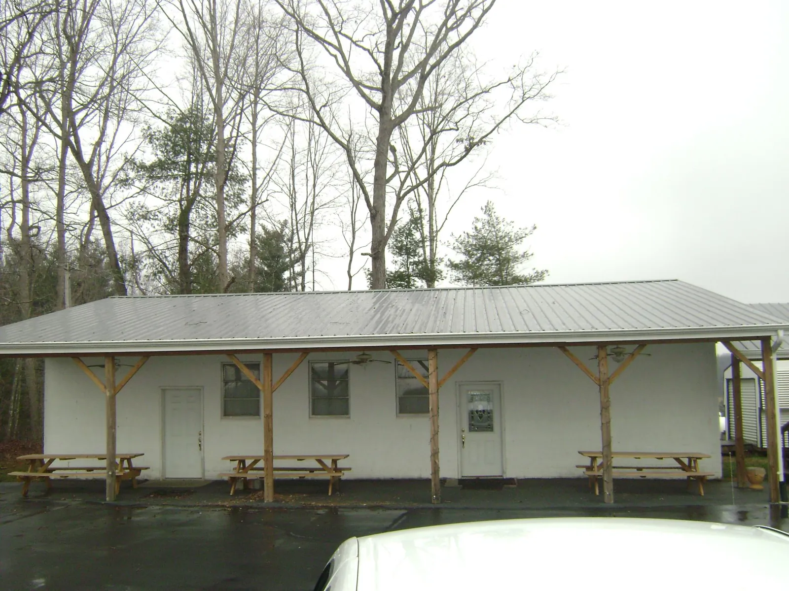 Gray metal roof over a block building with a timber post porch in Caseyville